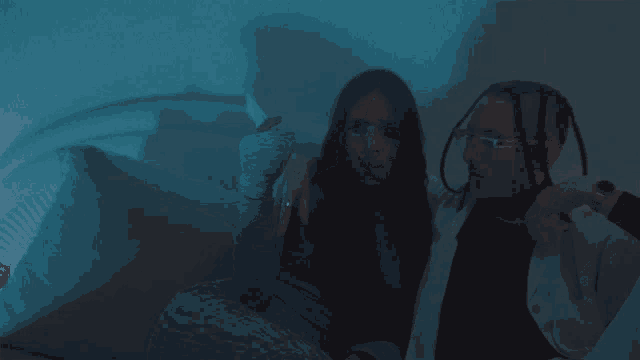 a man and a woman are sitting on a couch with the woman holding a stack of money