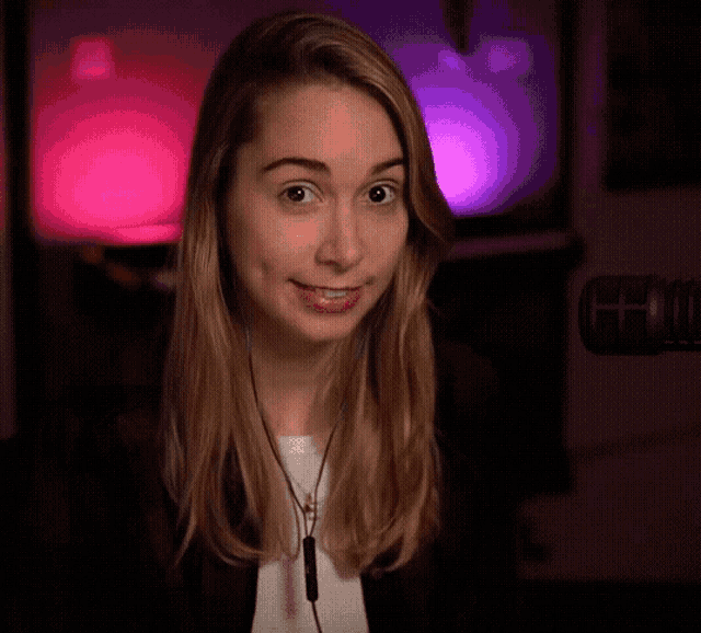 a woman wearing headphones is looking at the camera