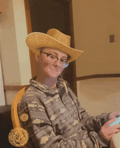 a person wearing a cowboy hat and glasses