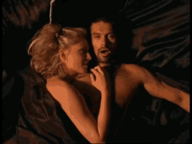 a man and a woman are laying on a bed with a blue circle around them