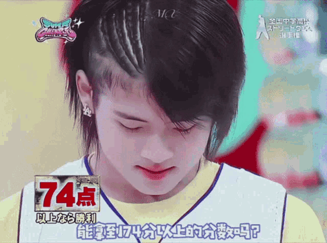 a boy with a braided haircut is wearing a jersey with the number 74 on the front