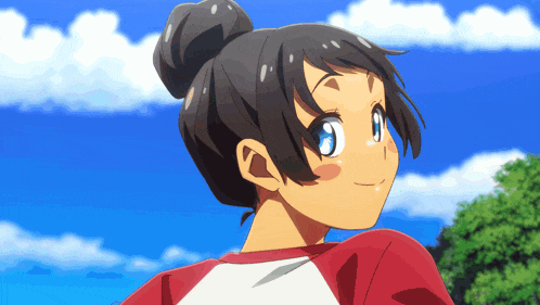 a girl with a bun in her hair is smiling and looking up at the sky