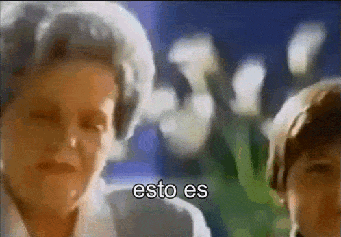 a blurry picture of a woman and a boy with the words esto es in the corner