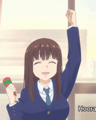 a girl in a suit and tie is holding her fist up in the air