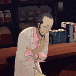 a man wearing glasses and a pink shirt is sitting at a counter