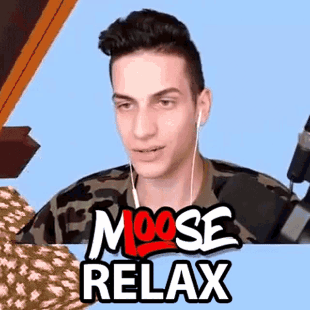 a man wearing ear buds is sitting in front of a moose relax sign