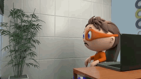 a cartoon character wearing a mask is sitting at a desk with a laptop