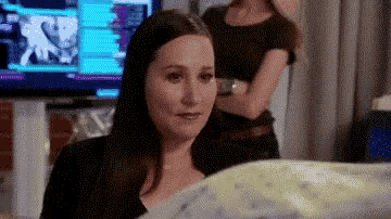 a woman is sitting in front of a television in a room .