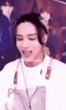 a close up of a person wearing headphones and an apron with a knife on it .