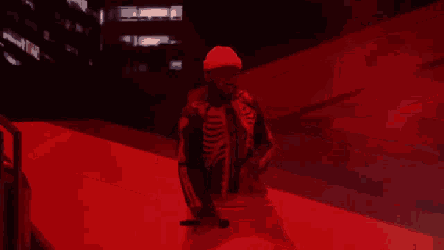 a man in a skeleton jacket is holding a microphone on stage