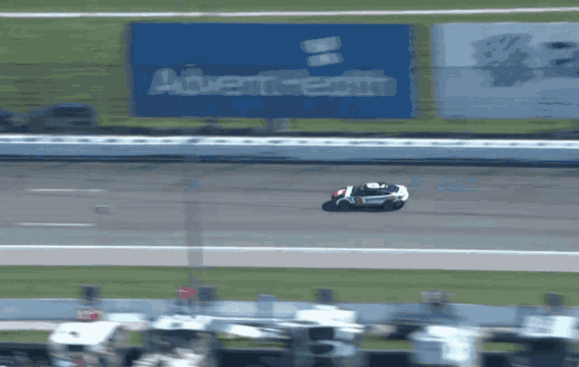 a motorcycle racer is flying through the air on a race track in front of a sign that says advent health
