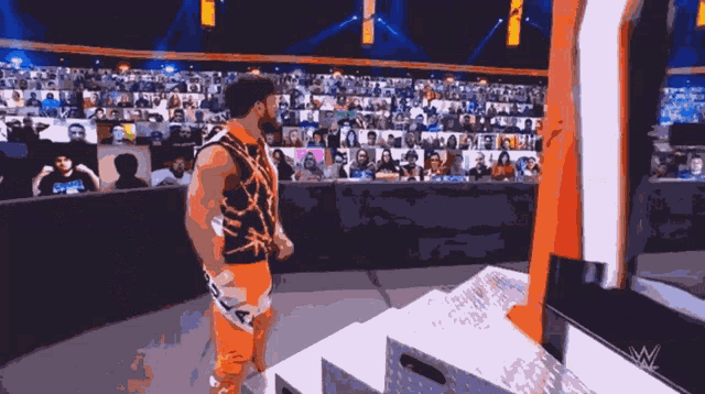 a cartoon of a wrestler standing in front of a crowd with the letter w on the bottom right
