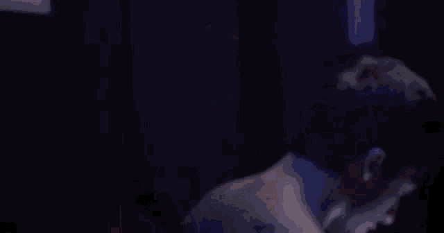 a close up of a man 's head in a dark room with a red light shining on it .