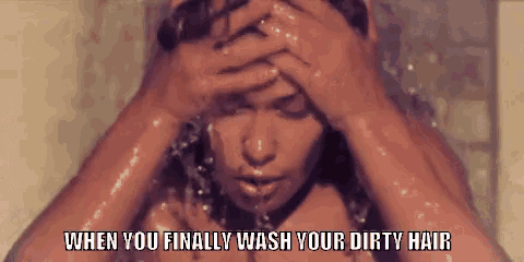 a woman is taking a shower with her hands on her head and the caption says `` when you finally wash your dirty hair '' .