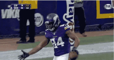 a football player wearing a purple jersey with the number 84 on it