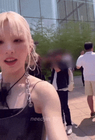 a woman in a black tank top is taking a picture of herself with the words needin written below her