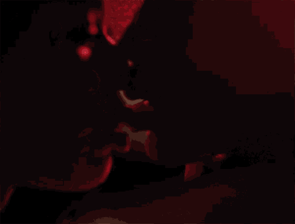 a close up of two women 's faces in the dark