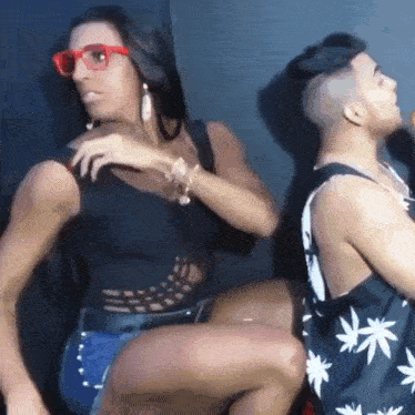 a man and a woman are dancing together in a dark room
