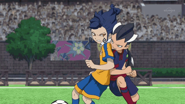 two soccer players on a field with a stadium in the background that says bs japan on the bottom