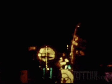a blurred image of a band with the words led zeppelin on the bottom right