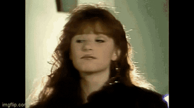 a close up of a woman 's face with red hair