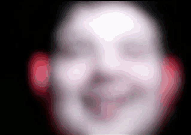 a blurry image of a person 's face with red headphones