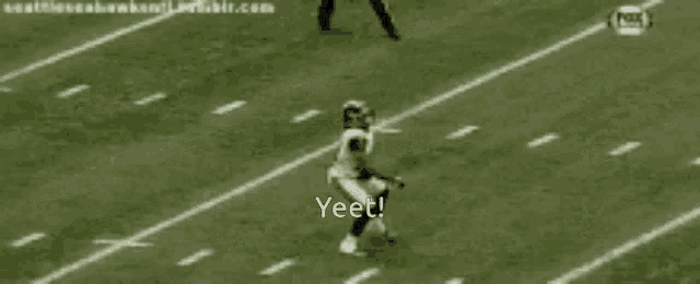 a black and white photo of a football game with the words yeet on the bottom right