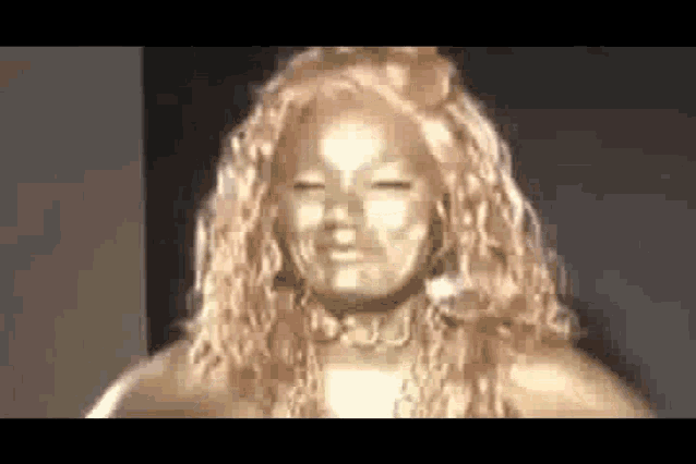 a woman with gold paint on her face looks like a statue