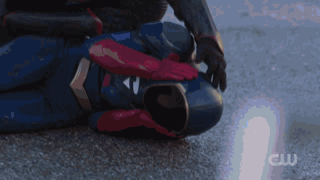 a person in a superhero costume laying on the ground