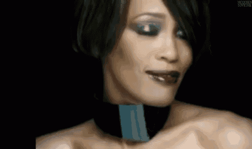 a close up of a woman 's face with the words no written on her chest .