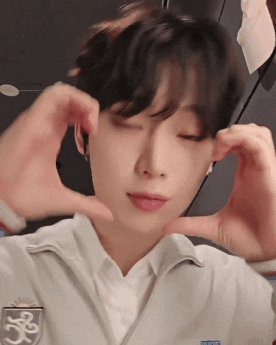 a person making a heart shape with their hands with the number 35 on it