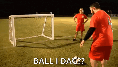 a man and a woman are playing soccer on a field and the man is asking the woman if the ball is in the goal .
