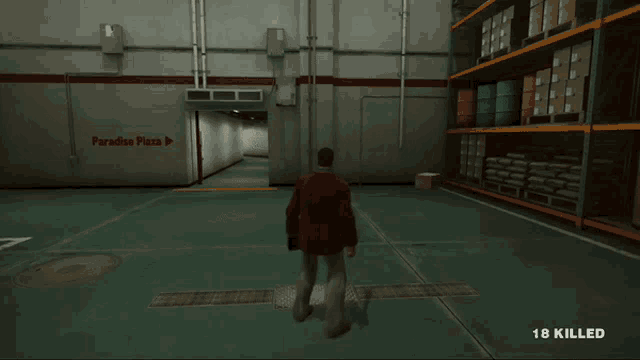 a man in a red jacket stands in a warehouse with paradise plaza written on the wall