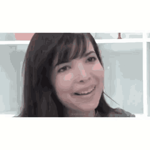 a close up of a woman 's face smiling .