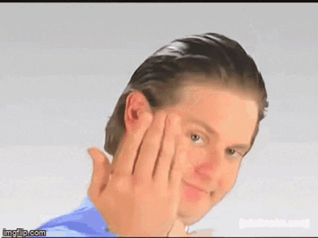 a man with a ring on his finger is making a face
