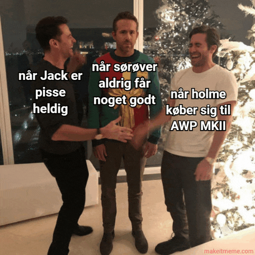 three men standing in front of a christmas tree with makeitmeme.com at the bottom of the image