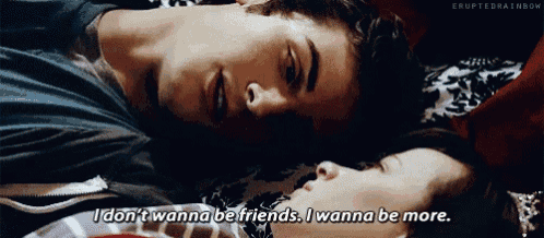 a man and a woman laying on a bed with the man saying " i don t wanna be friends i wanna be more