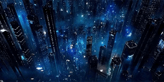 an aerial view of a futuristic city at night with a lot of buildings