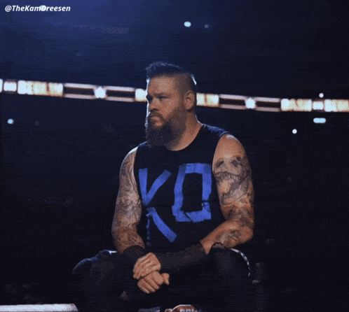 a man with a beard is wearing a shirt that says ko on it