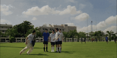 a group of people standing on a soccer field