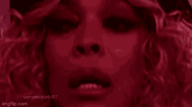 a close up of a woman 's face in red light