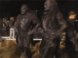 two orcs are standing next to each other in the mud