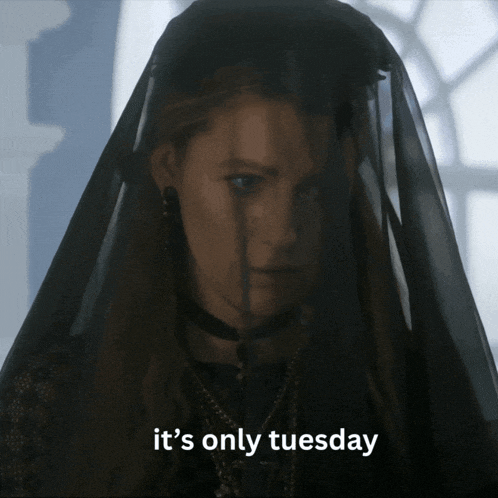 a woman with a black veil on her head and the words it 's only tuesday below her