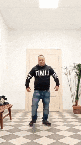 a man wearing a hoodie that says ' timij ' on the sleeves
