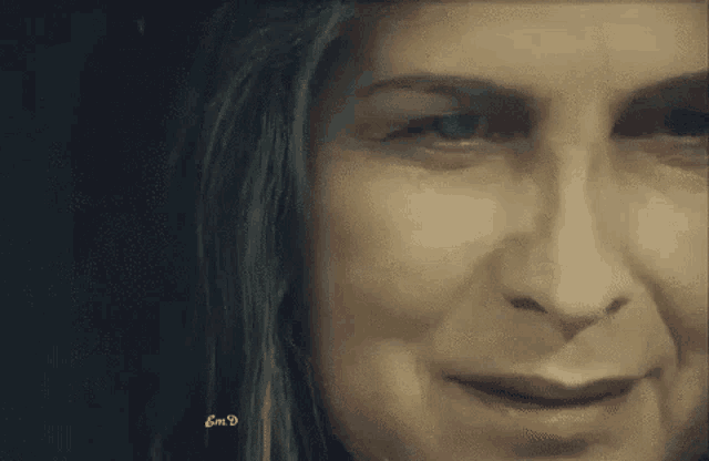 a close up of a woman 's face with the letters gmd on the bottom left
