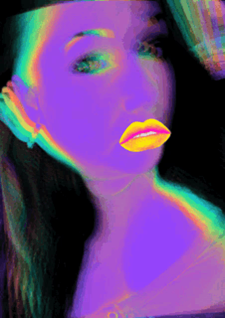 a woman 's face is glowing in purple and yellow