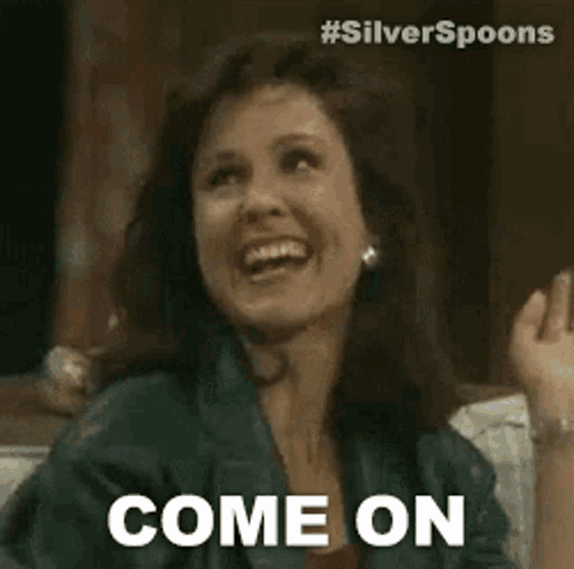 a woman is sitting on a couch and smiling while saying `` come on '' .