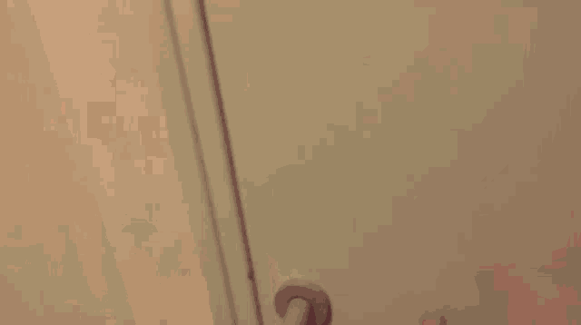a naked man is reading a newspaper in a bathroom