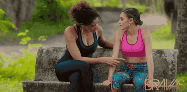 two women are sitting on a bench with the word bravas on the bottom