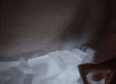 a pile of ice cubes in a dark room with steam coming out of them